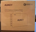 Aukey 6-PORT Desktop Charging Station -qualcomm Quick Charge 3.0 Tech Sealed. Fixed Price $55.00.